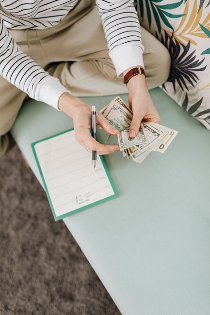 Open notebook with handwritten notes and a pen on a wooden table