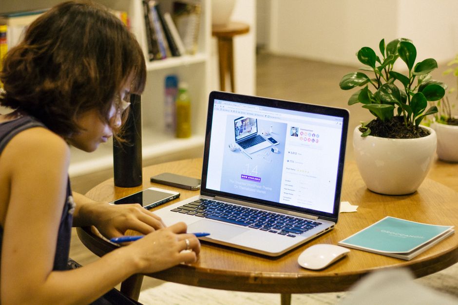 Open notebook on a table with a pen resting on it and a paper ribbon marking the page