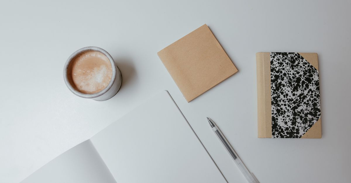 Close-up of a folded corner in a notebook with smudged ink and a coffee stain