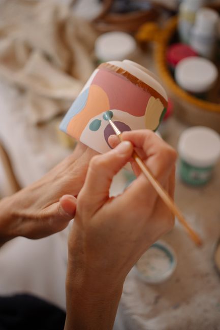 Ceramic cup with cream glaze and an irregular rim